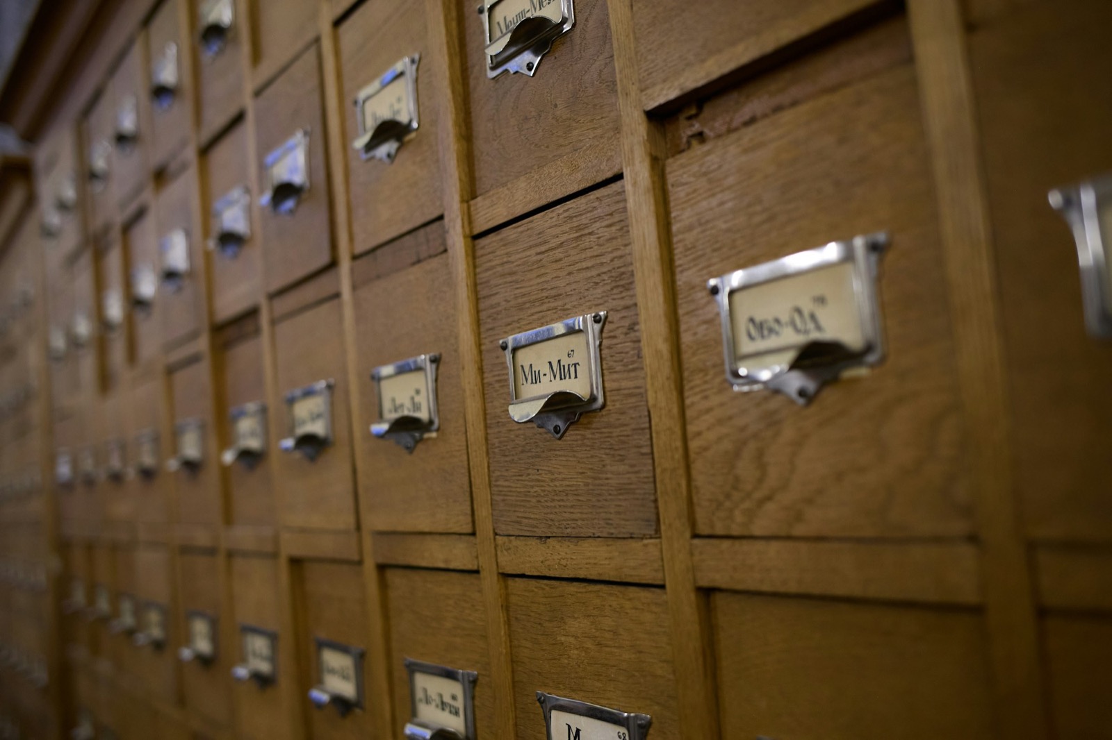 Rows of wooden index drawers, each with a label holder