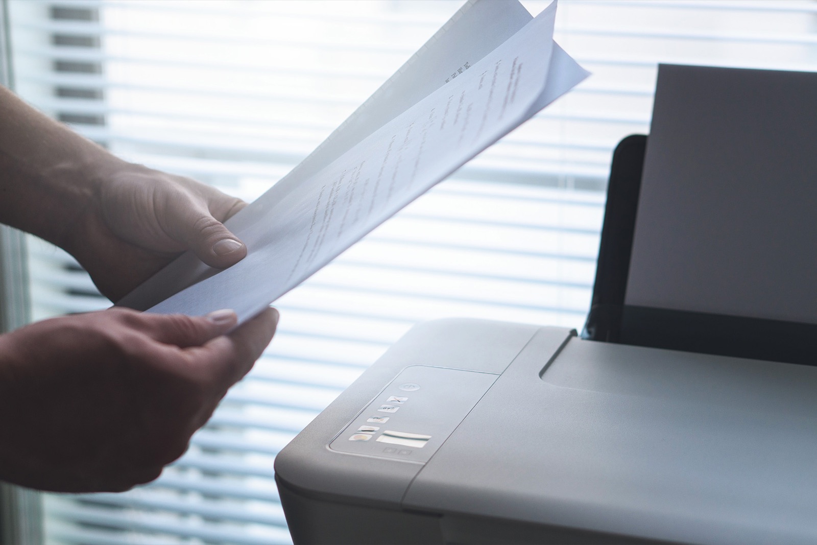 Printed pages being taken from a printer